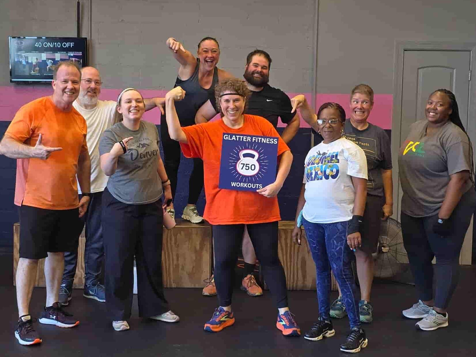 Diverse group of Glatter Fitness members celebrating 750 workouts and reaching fitness goals.