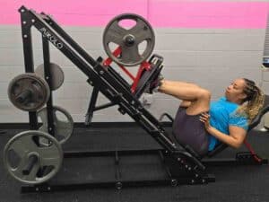 Glatter Fitness client performing a leg press exercise to build lower body strength and muscle mass.