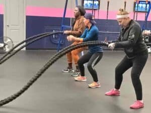 Glatter Fitness clients performing high-intensity battle rope exercises for cardiovascular endurance.