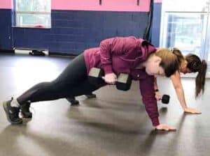 Glatter Fitness clients pushing limits during a plank exercise, emphasizing core strength and intensity.