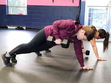 Glatter Fitness clients pushing limits during a plank exercise, emphasizing core strength and intensity.